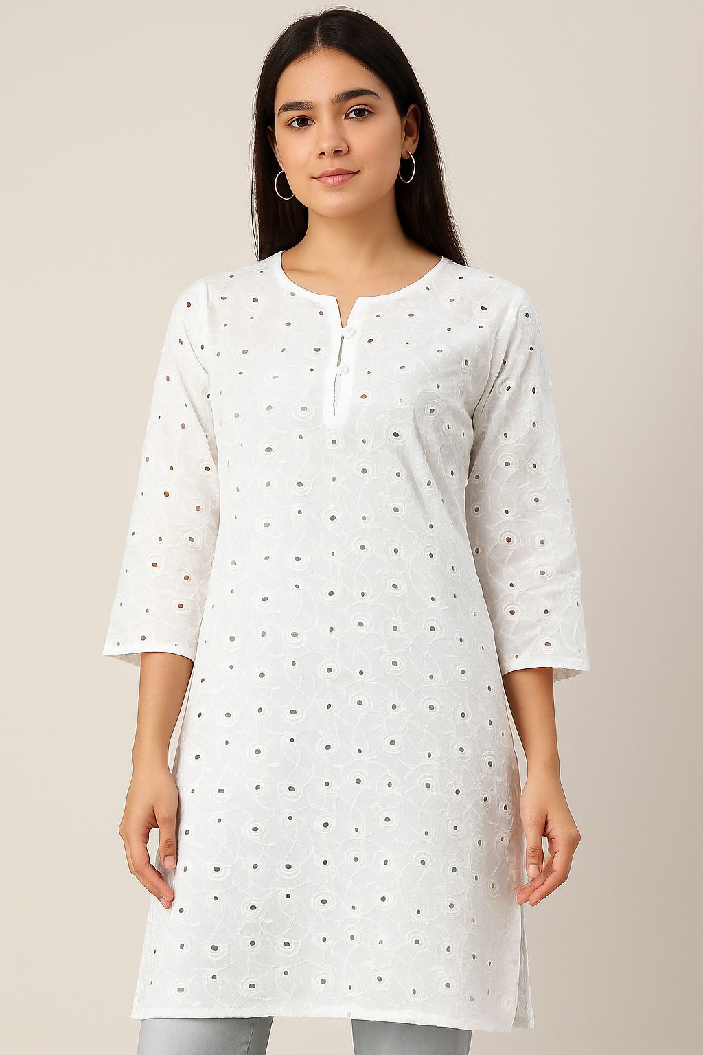 Close-up of premium white embroidered cotton textile (44 inches wide) ideal for designer tunics and summer fashion outfits.