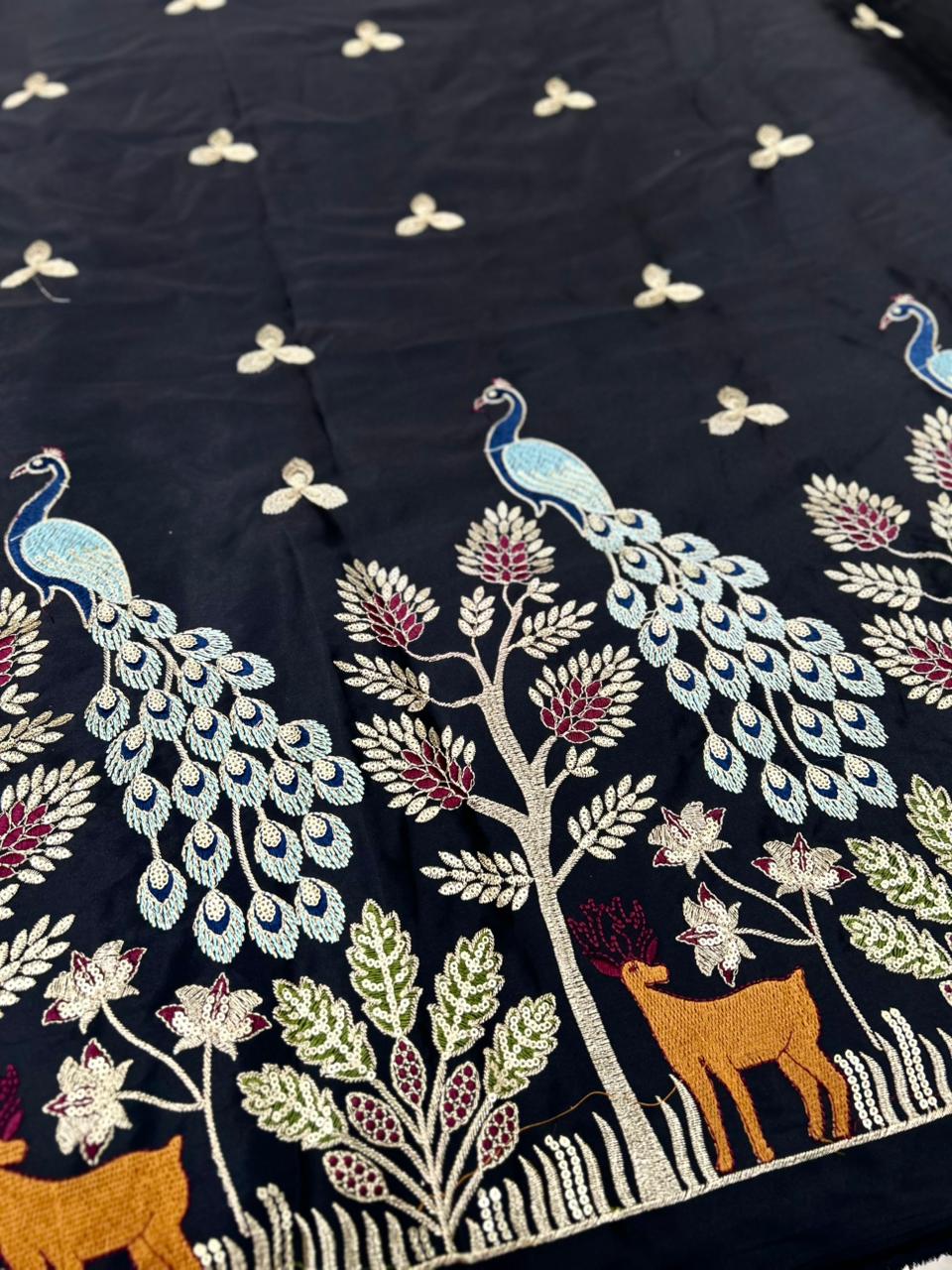 Black malai satin fabric featuring traditional peacock daman embroidery, ideal for royal wedding kurtas, festive ethnic wear and designer outfits.