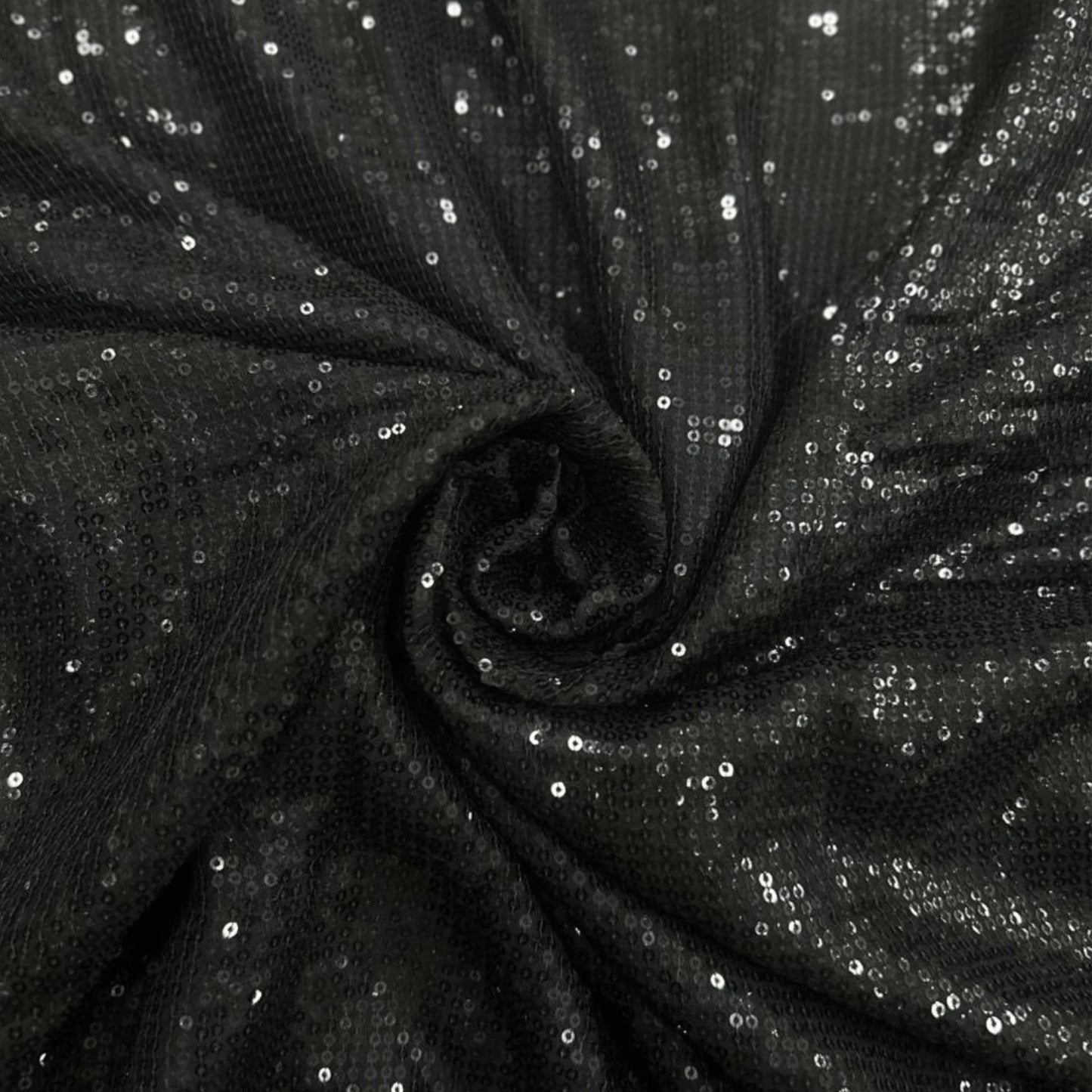 Luxury Black Sequin Georgette Fabric featuring dense all-over black sequins with a premium shimmer finish, beautifully draped to highlight its sparkle. Perfect for sarees, party wear gowns, cocktail dresses, lehengas and evening couture.
