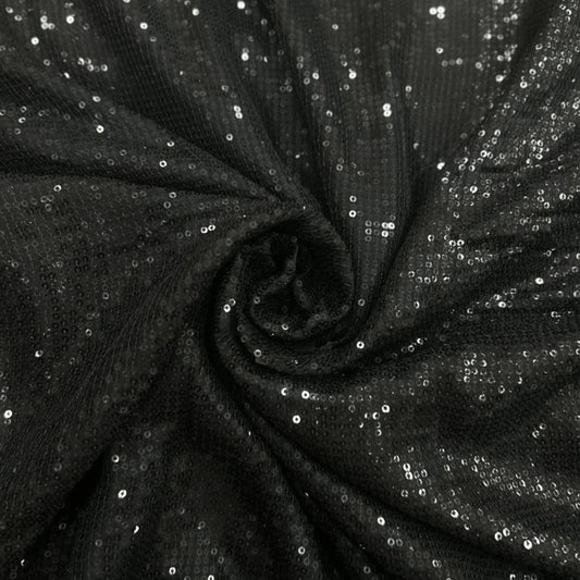 Luxury Black Sequin Georgette Fabric featuring dense all-over black sequins with a premium shimmer finish, beautifully draped to highlight its sparkle. Perfect for sarees, party wear gowns, cocktail dresses, lehengas and evening couture.