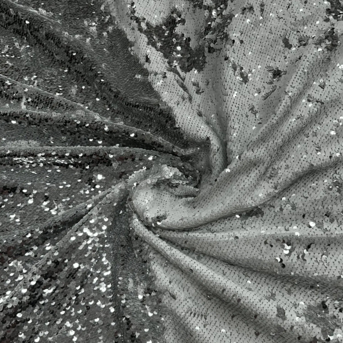 Close-up of Luxury Grey to Silver Reversible Sequin Net Fabric featuring heavy all-over reversible sequin work with a shimmering glitter finish. Soft drape ideal for bridal wear, gowns, party dresses, sarees, cocktail outfits and couture fashion.