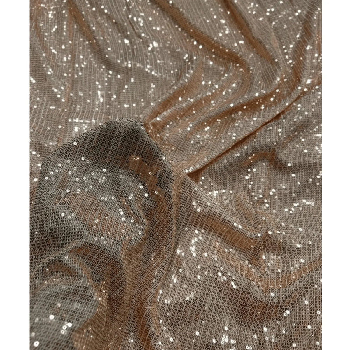 Premium Rose Gold sequin mesh fabric featuring dense shimmer embroidery and elegant folds. Ideal for wedding wear, evening gowns, festive dresses and designer apparel.