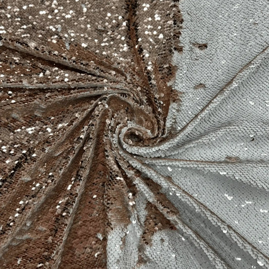Premium reversible rose gold and white sequin net fabric featuring two-way flip sequins on soft mesh. Ideal for designer gowns, cocktail dresses, bridal wear, stage costumes and festive outfits.
