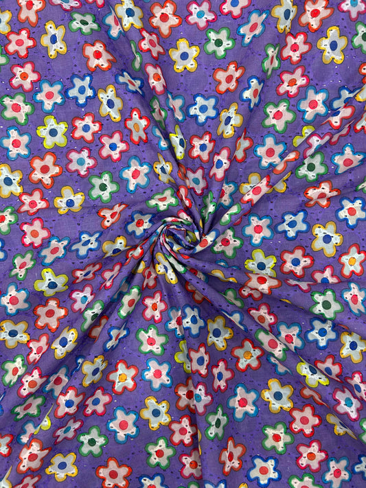 Close-up of breathable 100% cotton textile with a bright purple background and cheerful embroidered flower cutouts, ideal for kurtas and sophisticated outfits.