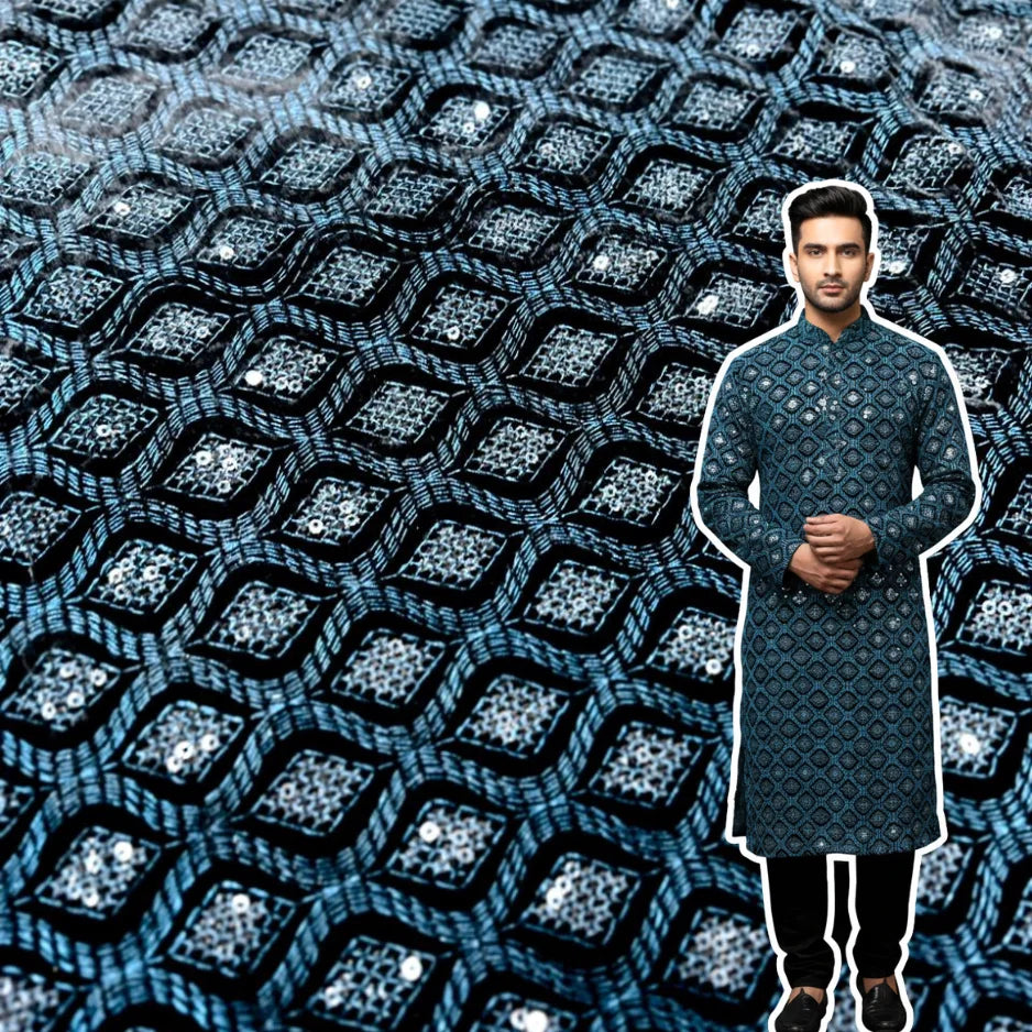 Close-up view of premium teal blue velvet fabric with heavy thread embroidery and sequin detailing.