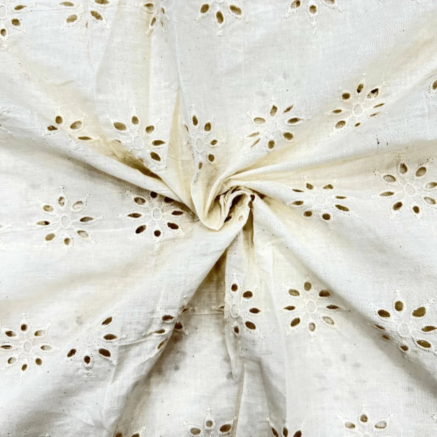 Premium Unique Hakoba Dyeable Cotton Schiffli Fabric with elegant floral eyelet embroidery on soft breathable pure cotton. Dyeable fabric ideal for kurti, dresses, tops, kidswear, ethnic wear and custom fashion. 44-inch width.