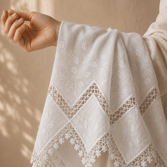 Premium white applique embroidery fabric with elegant cutwork border and floral embroidery.