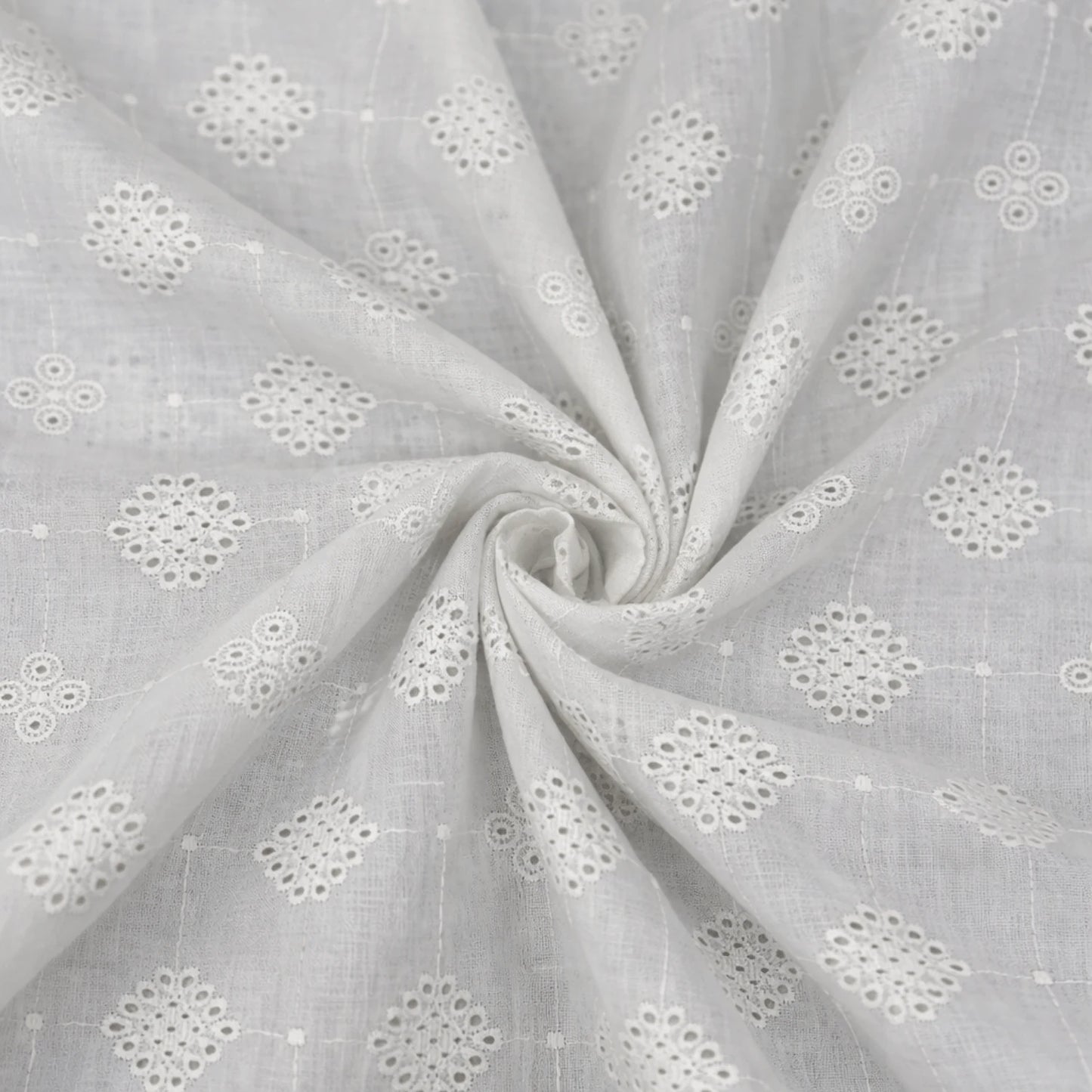 Premium white Hakoba cotton Schiffli embroidery fabric featuring elegant geometric floral eyelet embroidery. Soft, breathable 100% cotton fabric with 58-inch width, ideal for kurtis, dresses, tops, co-ord sets, kidswear and ethnic wear.