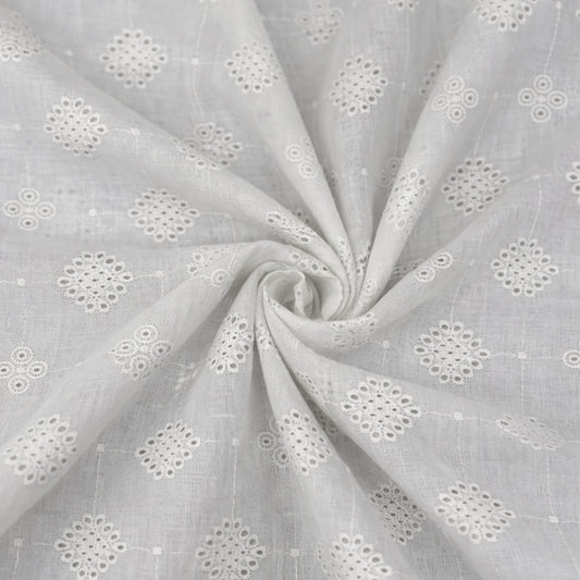 Premium white Hakoba cotton Schiffli embroidery fabric featuring elegant geometric floral eyelet embroidery. Soft, breathable 100% cotton fabric with 58-inch width, ideal for kurtis, dresses, tops, co-ord sets, kidswear and ethnic wear.