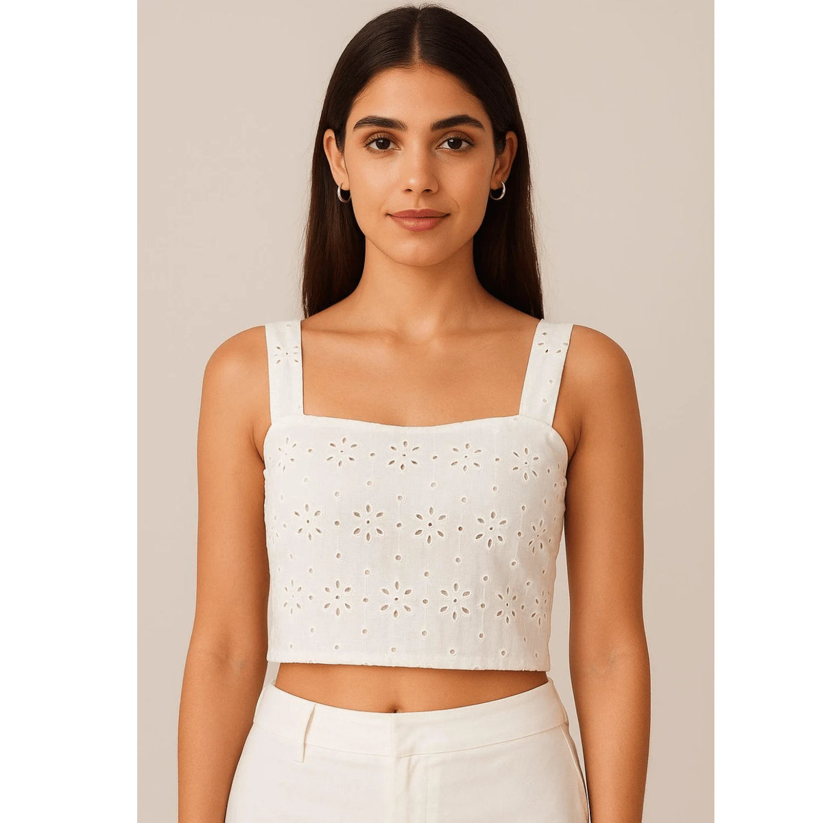 Women's white crop top stitched from premium Hakoba Schiffli cotton fabric with elegant floral eyelet embroidery. Soft breathable cotton fabric, 56 inch width, perfect for tops, blouses, dresses and summer fashion.