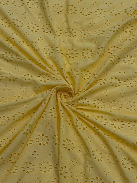 Yellow cotton hakoba fabric with floral cutwork design for kurti, dress, kurta, and shirt.
